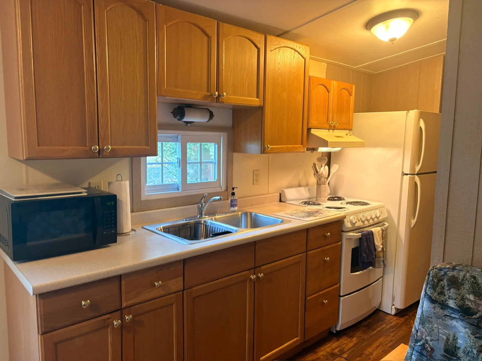 East Oak Lane 2 — Kitchen with oak cabinets, double sink, microwave, electric range and full-size refrigerator