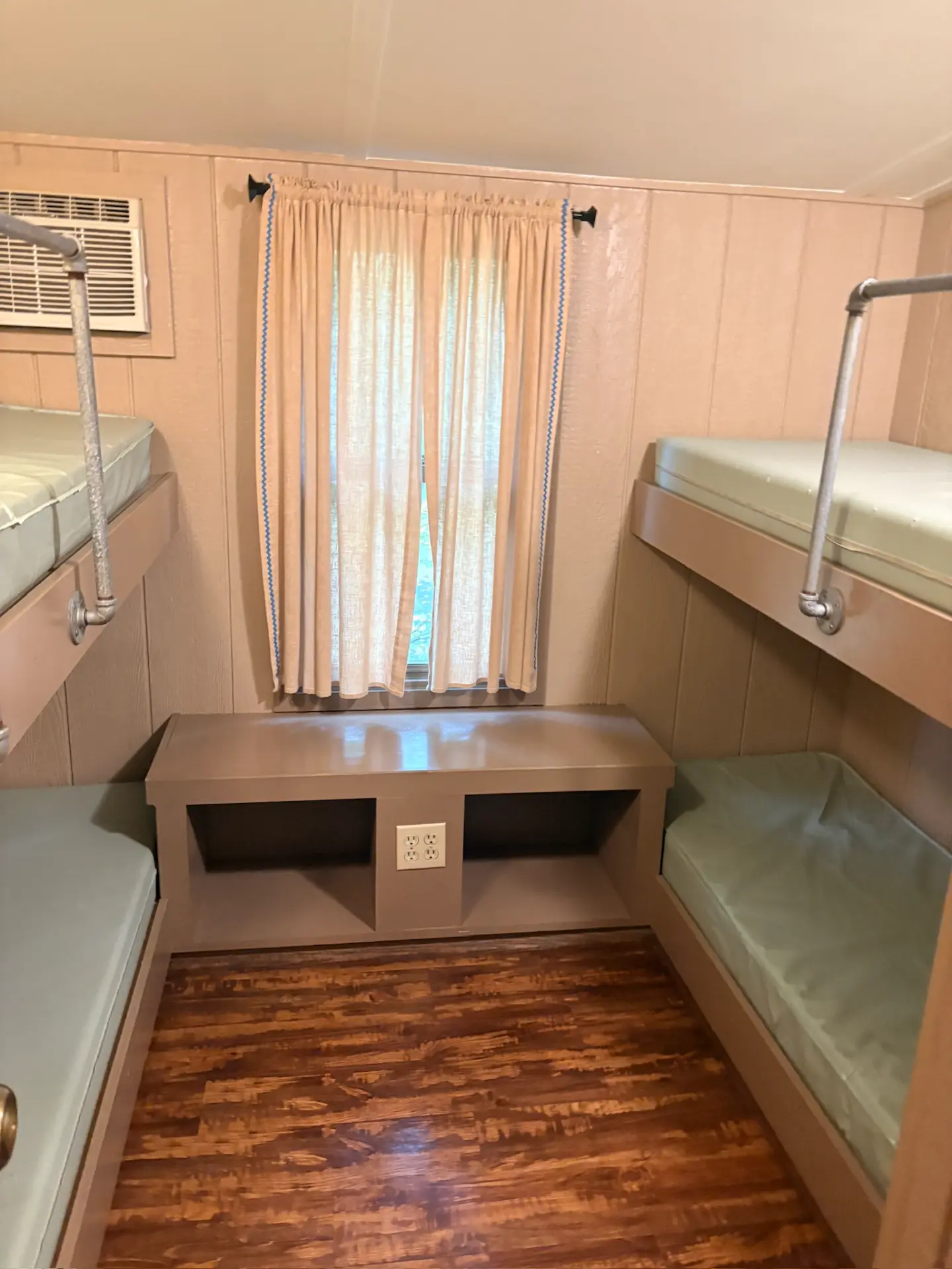 East Oak Lane 2 — Bunk room with four single bunks and a storage bench under the window