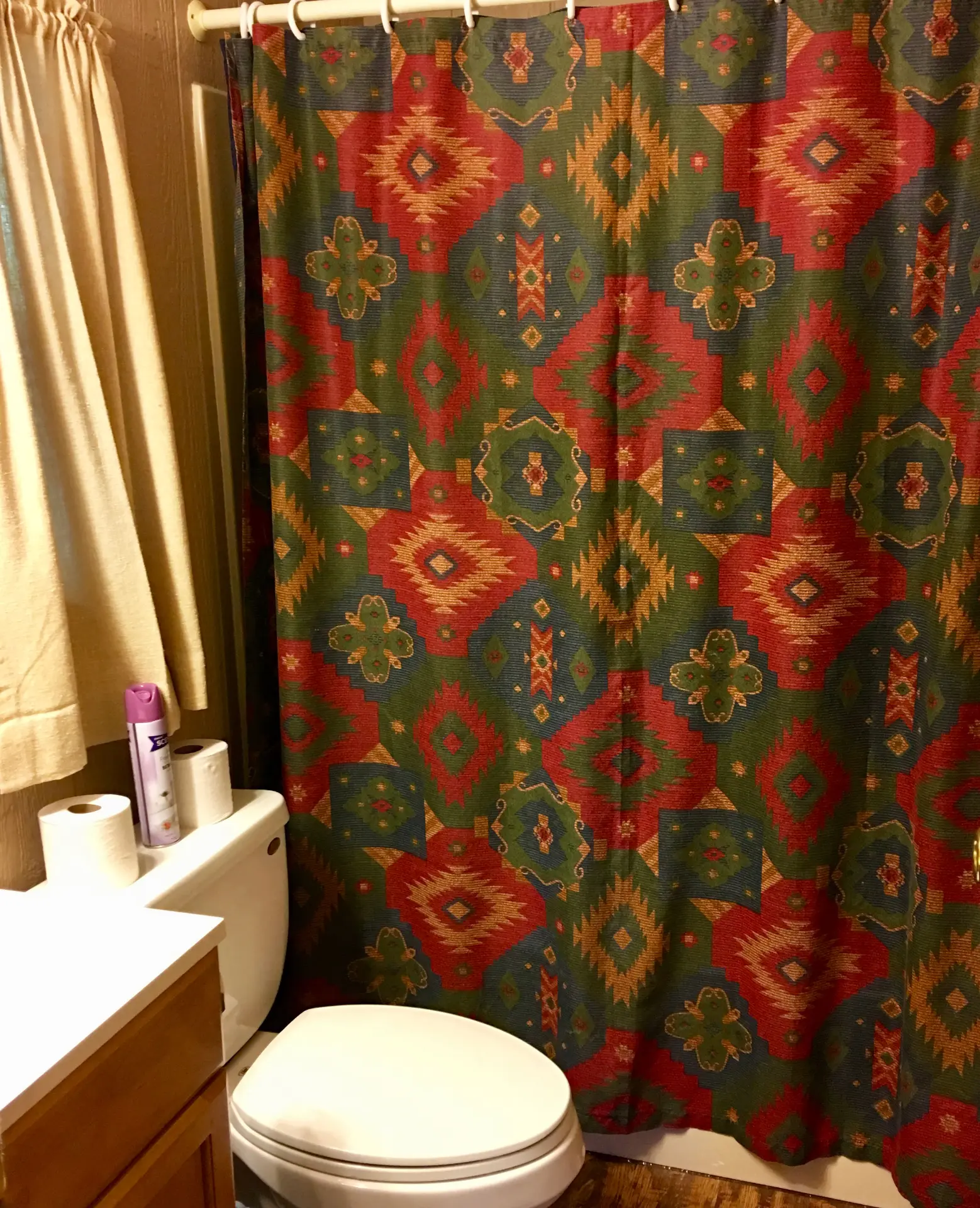 West Oak Lane 9 — Full bathroom with vanity, toilet and shower/tub with a southwest-pattern curtain