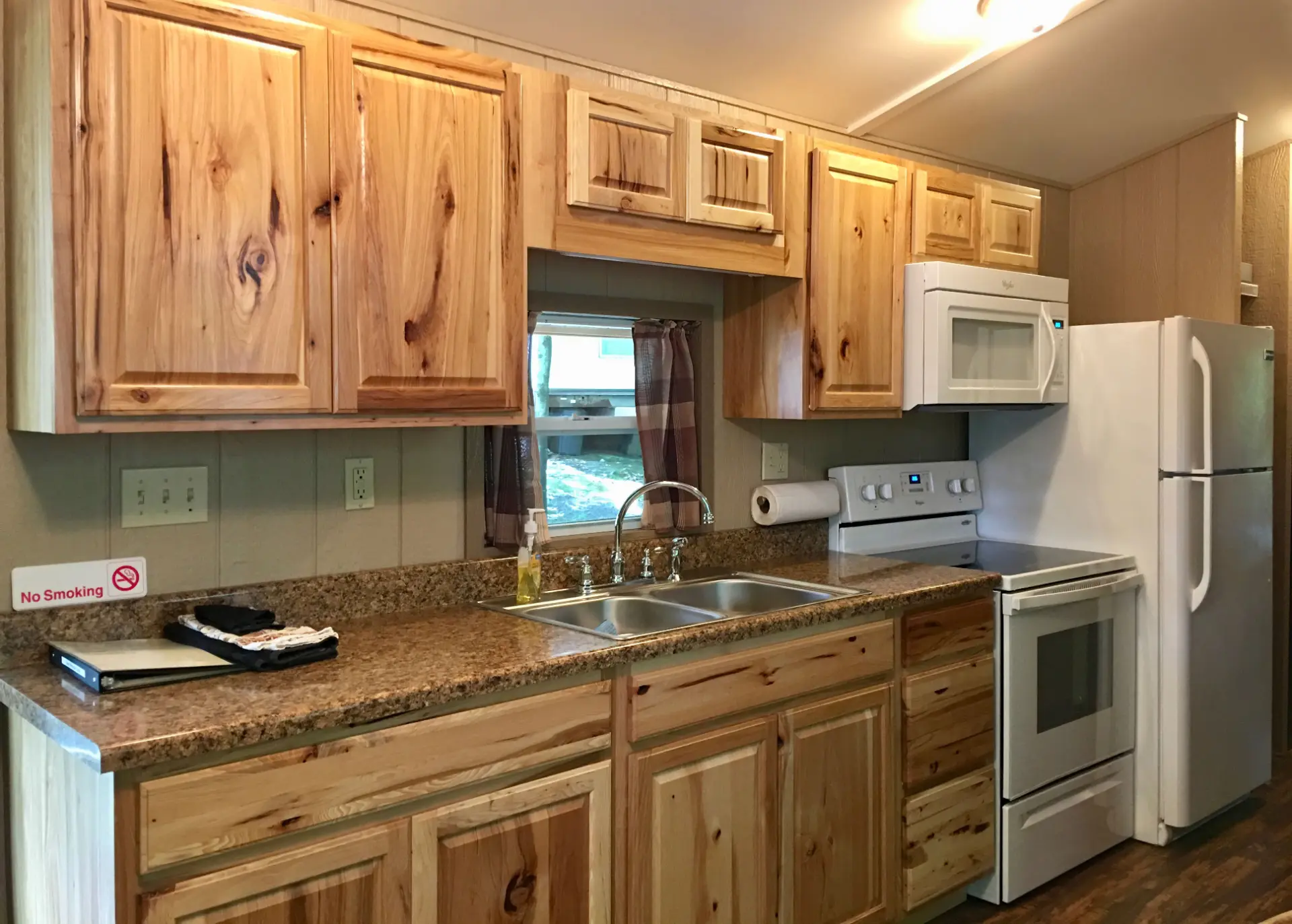 West Oak Lane 9 — Kitchen with hickory cabinets, granite-look counters, full-size range, microwave and refrigerator